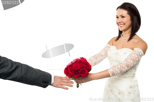 Image of Bride offering her token of love to the groom