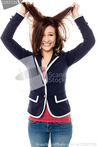 Image of Young girl pulling her hair in excitement