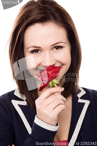 Image of Lovely young girl with a beautiful red rose