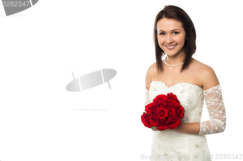 Image of Pretty bride posing with love red roses bouquet