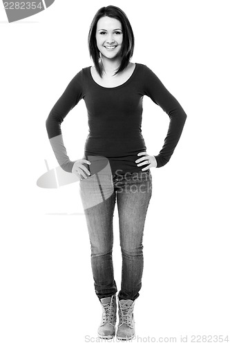 Image of Fashionable girl with hands on waist