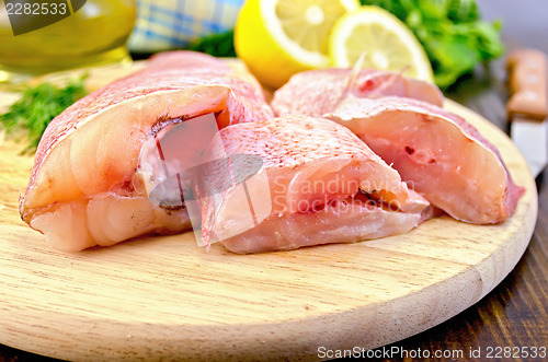 Image of Fillet of sea bass with oil and a knife