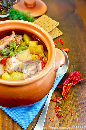 Image of Roast chicken in a clay pot on a napkin