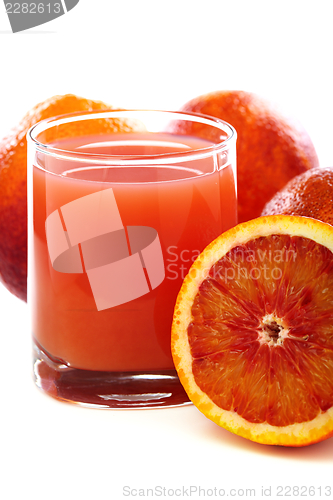 Image of Glass with juice and blood oranges.