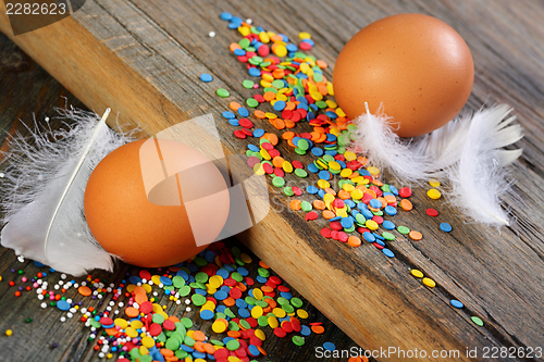 Image of Eggs, feathers and Easter decorations.