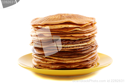 Image of Stack of pancakes on a yellow plate.