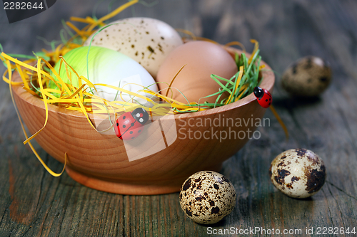 Image of Easter eggs in a wooden bowl.