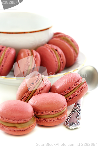 Image of Almond cakes and a cup with teaspoon.