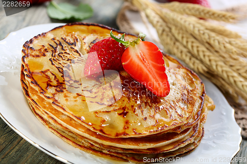 Image of Pancakes with honey sauce.