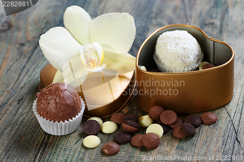 Image of White Orchid and handmade chocolates.