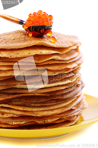 Image of Stack of pancakes and a spoon with red caviar.