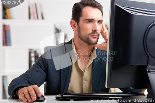 Image of Man Looking At A Computer Monitor