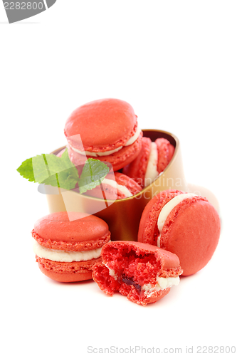 Image of Macaroons with cream of mint and a cherry. 