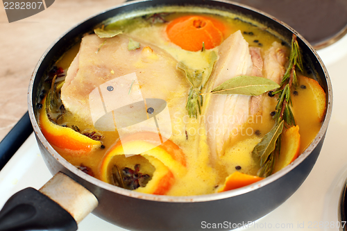Image of Pork loin in orange juice with spices.