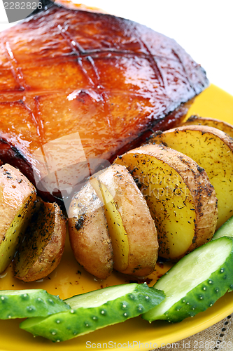 Image of Pork cucumbers in an orange glaze with roasted potatoes.