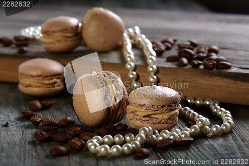 Image of Almond cakes, coffee beans and pearl.