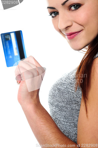Image of Fashionable young girl holding up a credit card