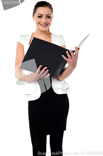 Image of Female secretary reviewing companys file