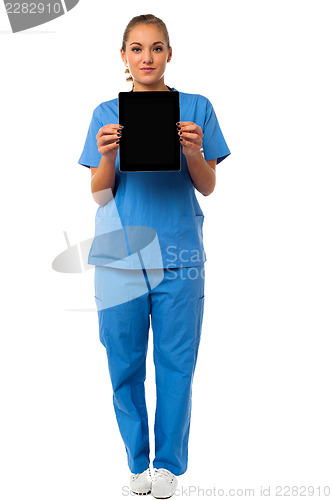 Image of Pretty doctor showcasing a portable tablet