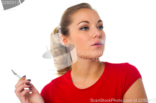 Image of Young woman with cigarette in hand