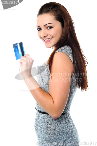 Image of Fashionable young girl holding up a credit card