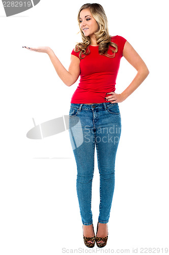 Image of Lovely young female presenting copy space