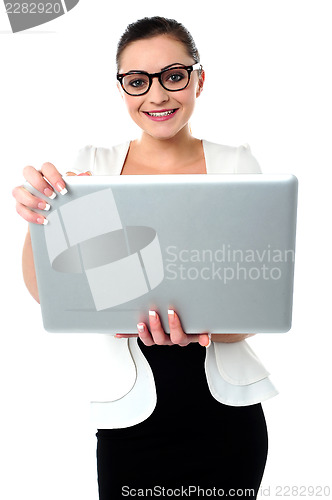 Image of Bespectacled woman holding a laptop