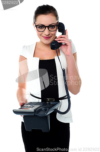 Image of Bespectacles secretary answering a call