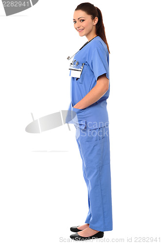 Image of Title:Side pose of a young female doctor in uniform