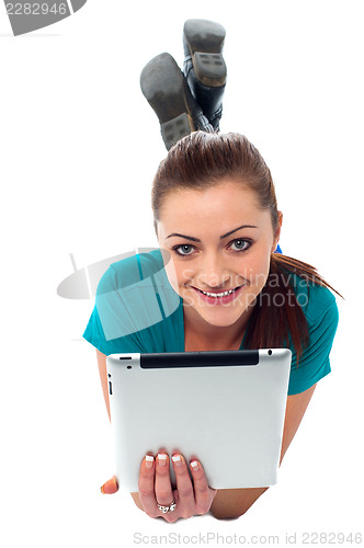 Image of Pretty girl browsing on her tablet pc