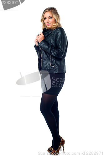 Image of Attractive young female model in leather jacket