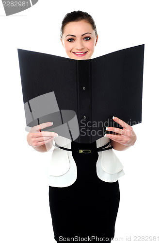 Image of Cheerful woman looking at the file in hands