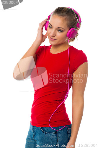 Image of Girl listening to music through headphones