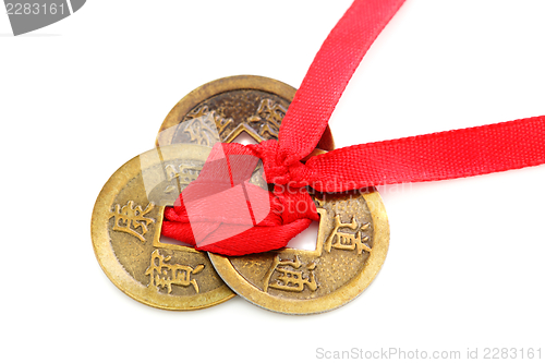 Image of Three Chinese coins tied with red ribbon.