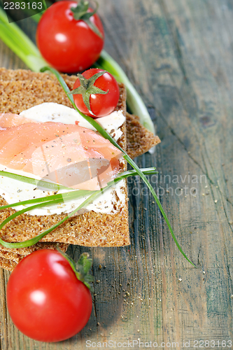 Image of Bread with salmon, cream cheese and green onions. 