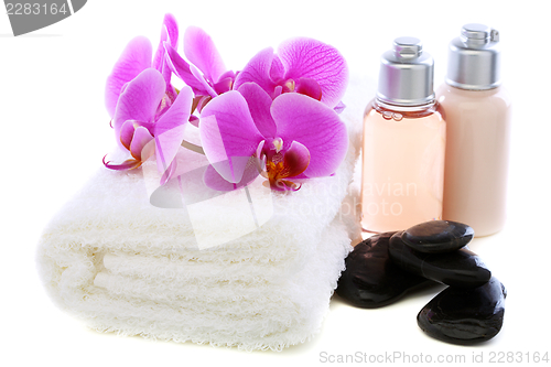 Image of Set basalt stones, towel and orchid.