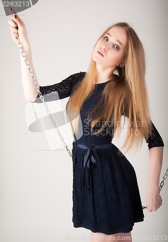 Image of beautiful fashionable woman near chain swing