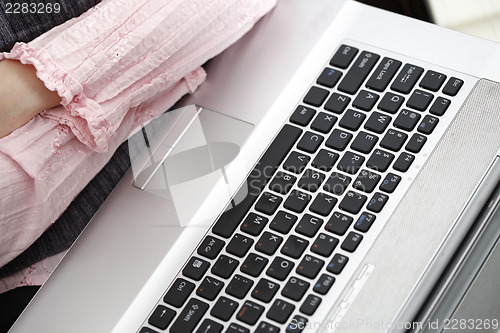 Image of Young woman working on laptop