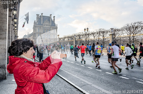 Image of Spectators and participants of the annual Paris Marathon on the 