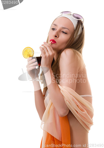 Image of Caucasian woman drinks unrecognizable cocktail