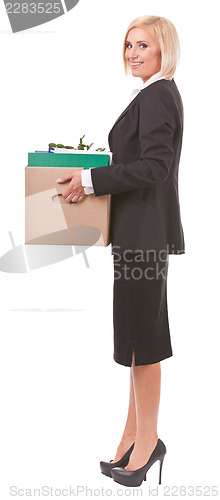 Image of Happy young woman moving personal things