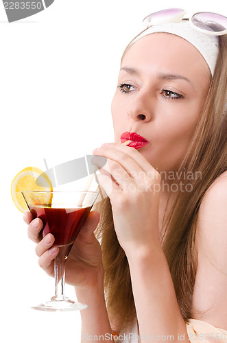 Image of Caucasian woman drinks unrecognizable cocktail