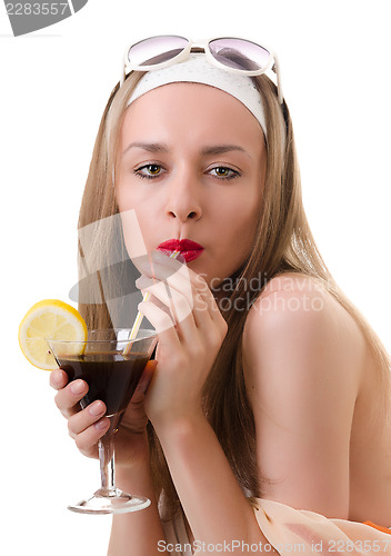 Image of Caucasian woman drinks unrecognizable cocktail