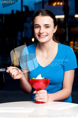 Image of Girl enjoying tempting dessert