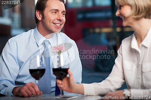 Image of Happy couple drinking red wine at a restaurant