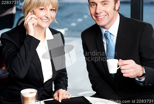 Image of Two business professionals at coffee shop