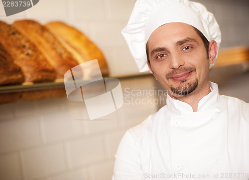 Image of Bakery owner dressed in chef's attire