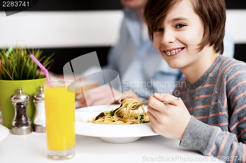 Image of Boy enjoying food and fresh juice