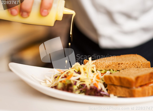 Image of Mayonnaise sauce poured on a vegetable salad