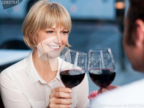 Image of Couple toasting in a restaurant